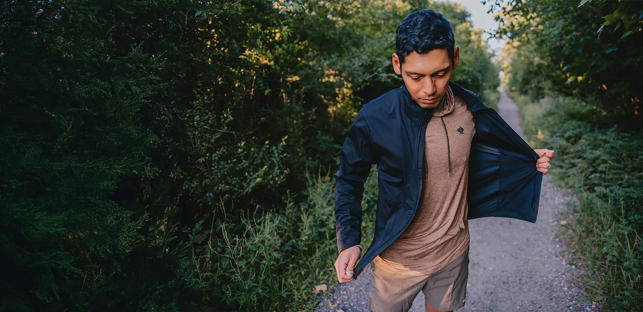 trail runner taking off jacket