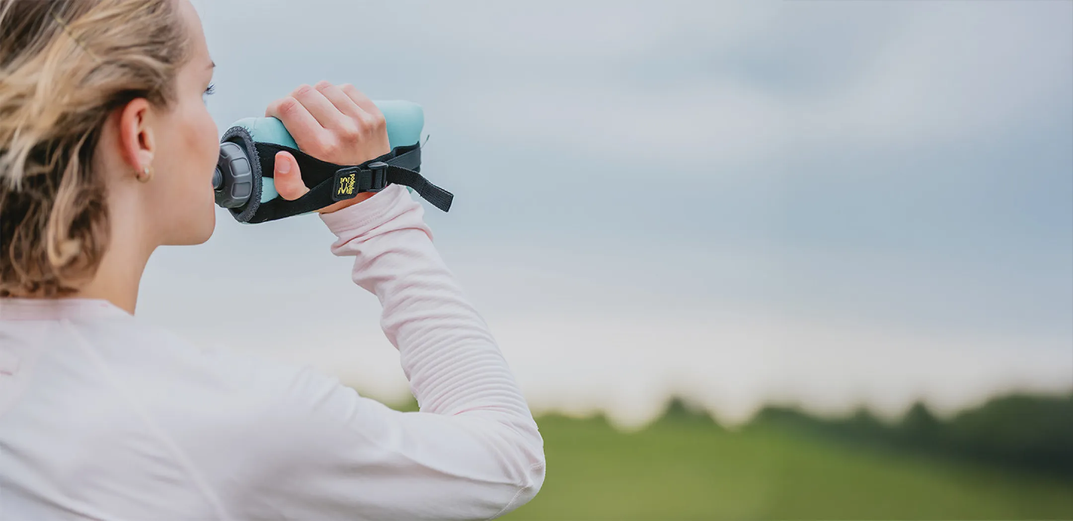 Runner drinking from amphipod water bottle