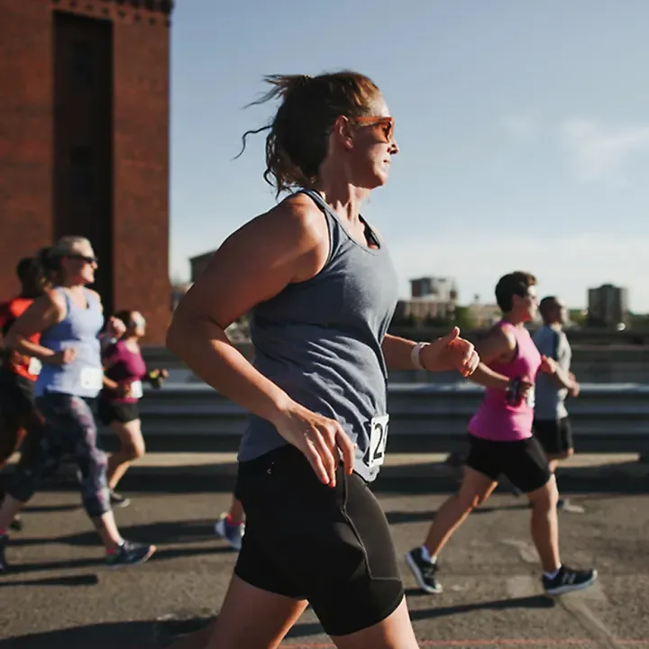 A runner runs with a Fleet Feet group