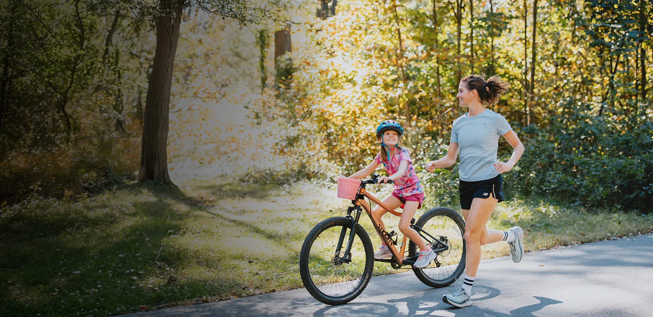 Mother running alongside daughter riding bike - mother’s day gifts for runners women